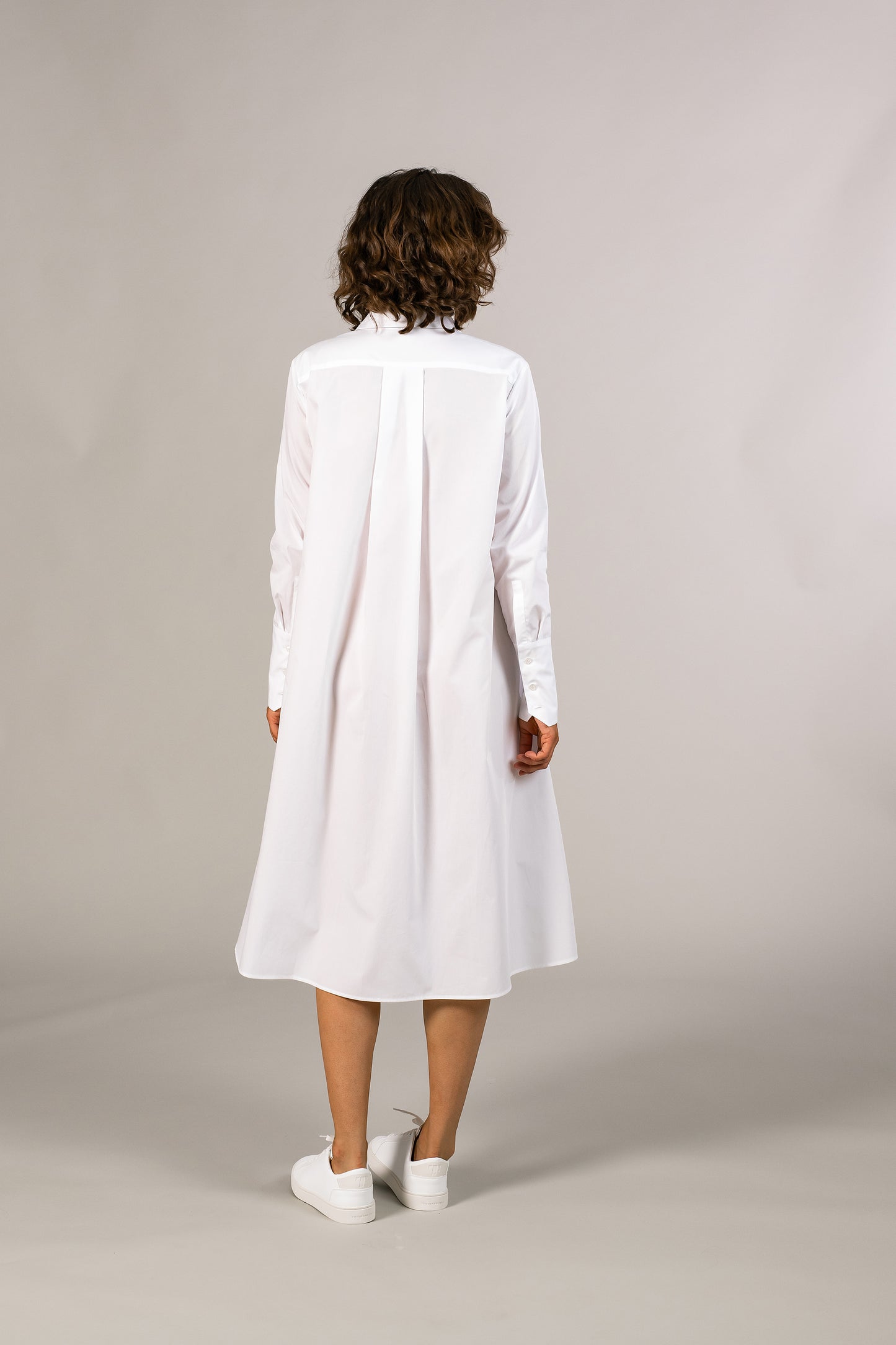 Back view of womens white tuxedo shirt dress, 100% sustainable cotton poplin from Italy, long sleeve, button down knee length.