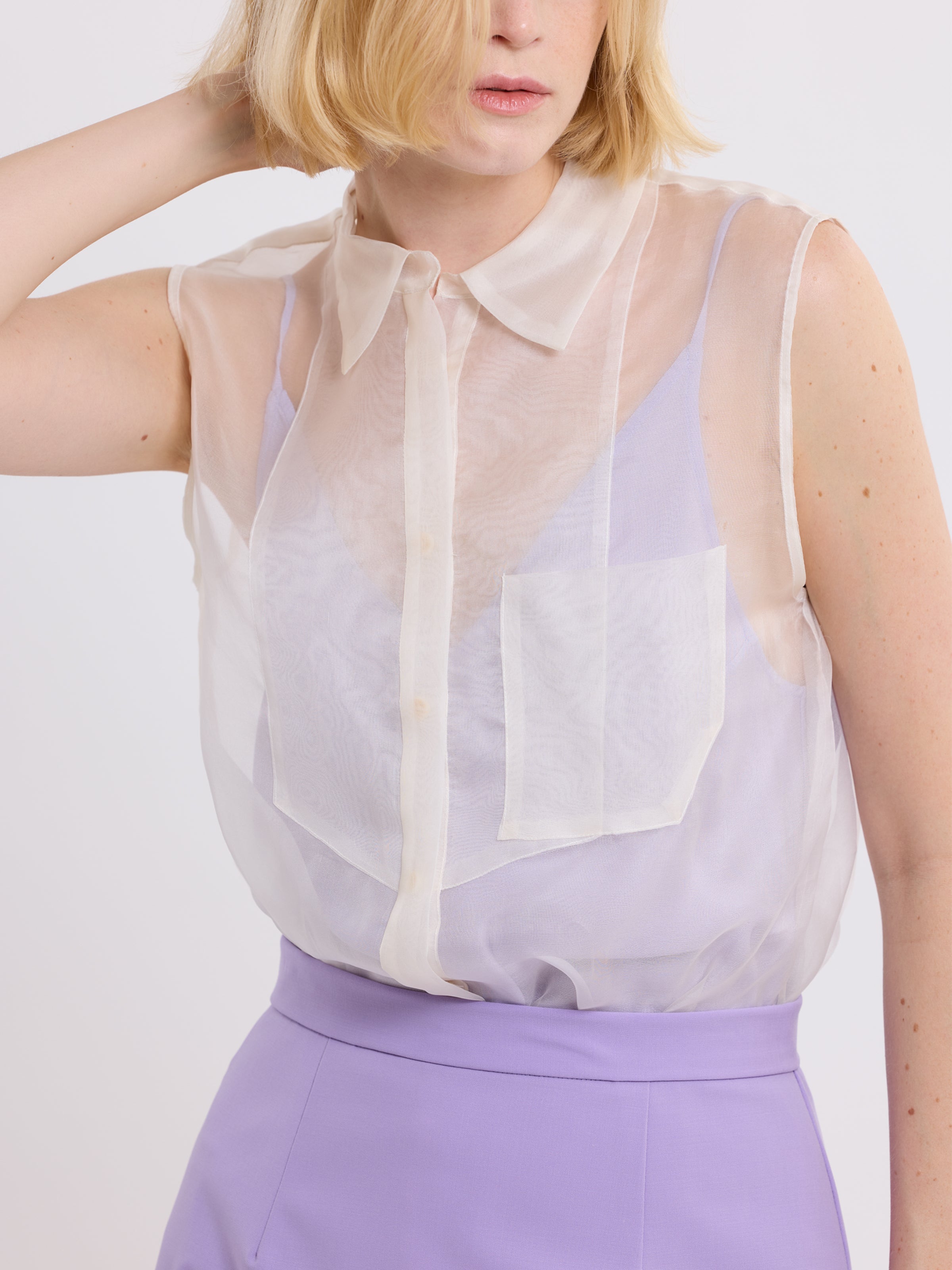 Close up view of organza button down tuxido shirt on model in creme color