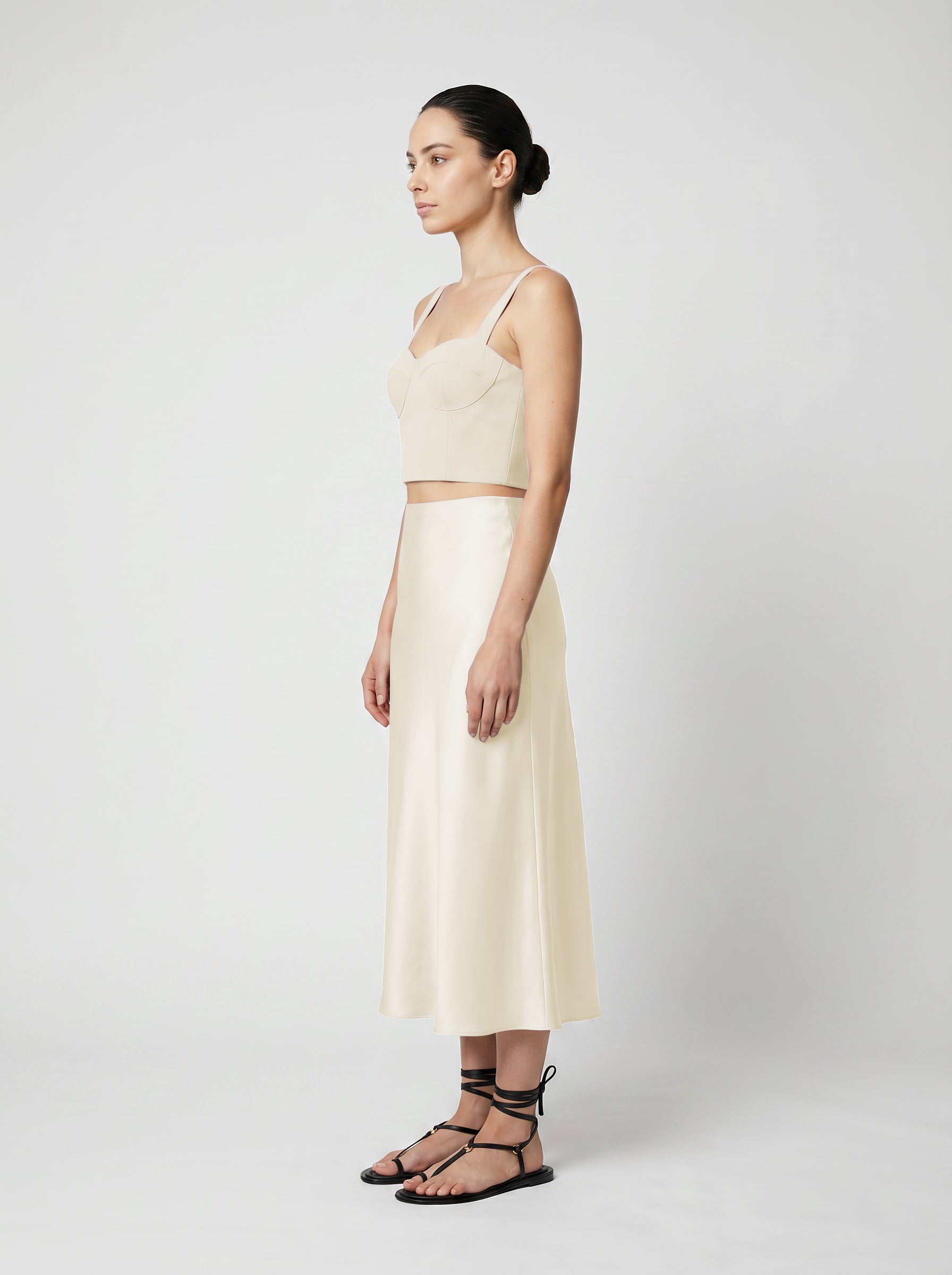creme color Wool corset top with silk slip skirt on model side view