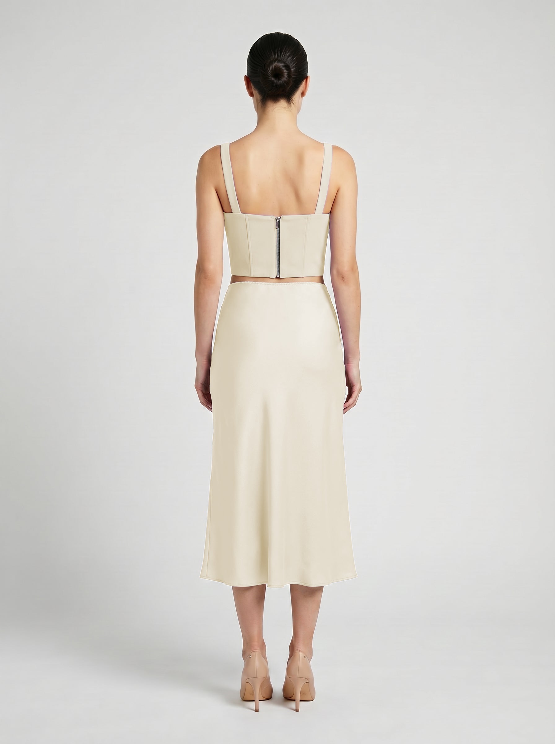 creme color wool corset top with silk slip  skirt on model back view