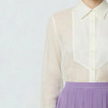 White sheer blouse with a purple skirt on a white background