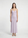 Woman wearing a light purple slip dress on a white background 