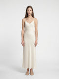 Woman wearing a white slip dress on a white background