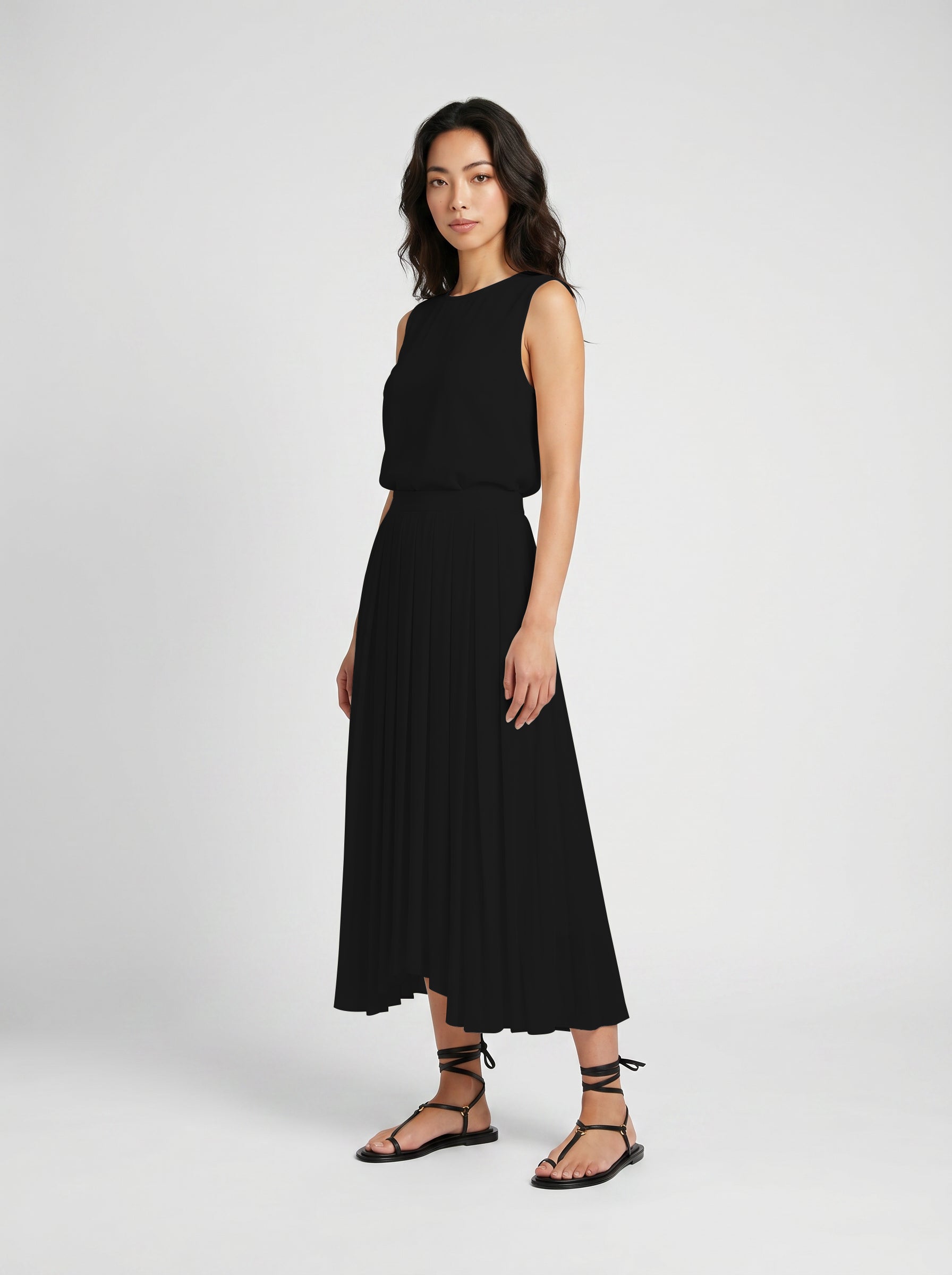 black pleated organic silk skirt on model side view
