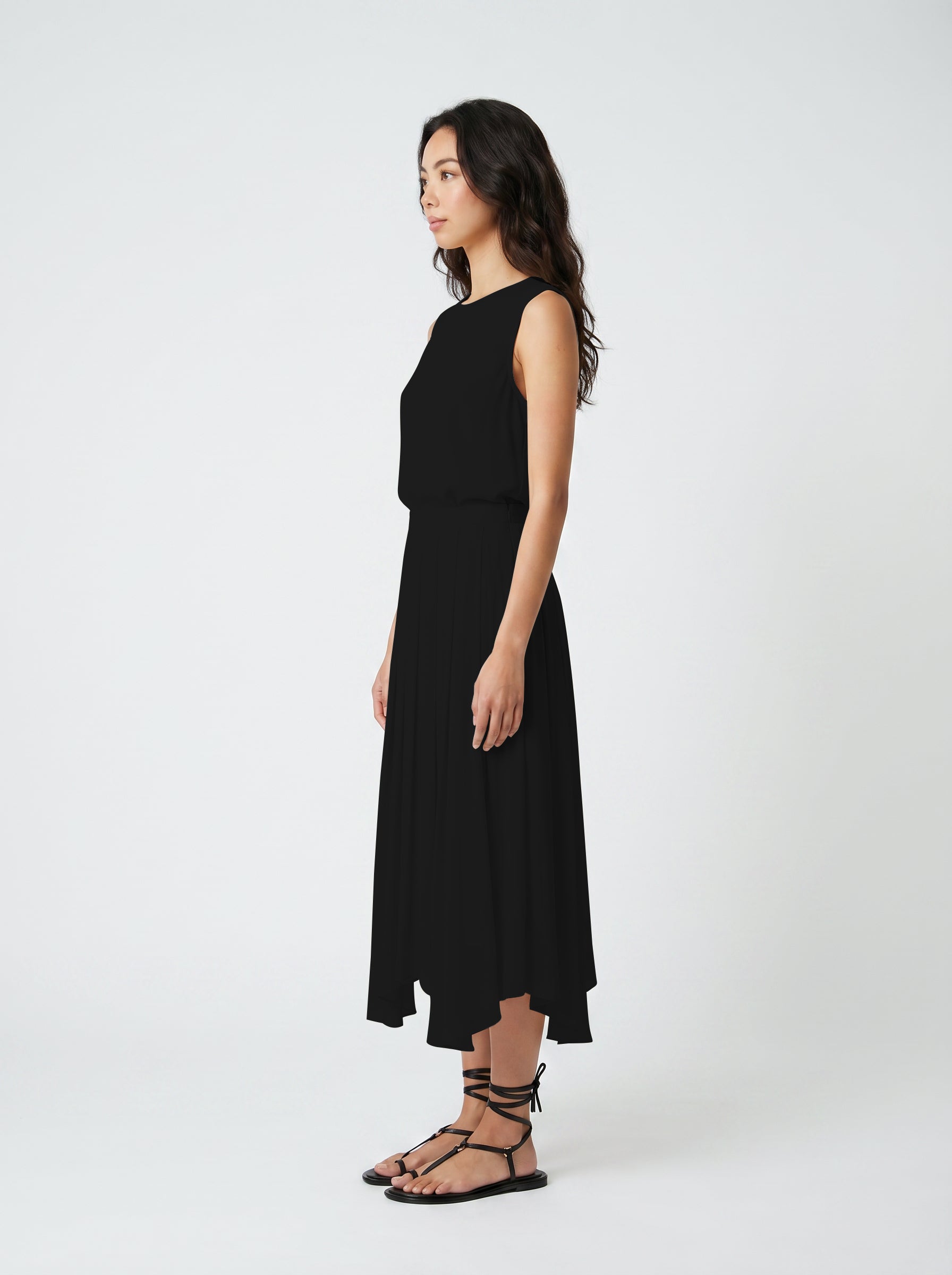 black pleated organic silk skirt on model  three quater view