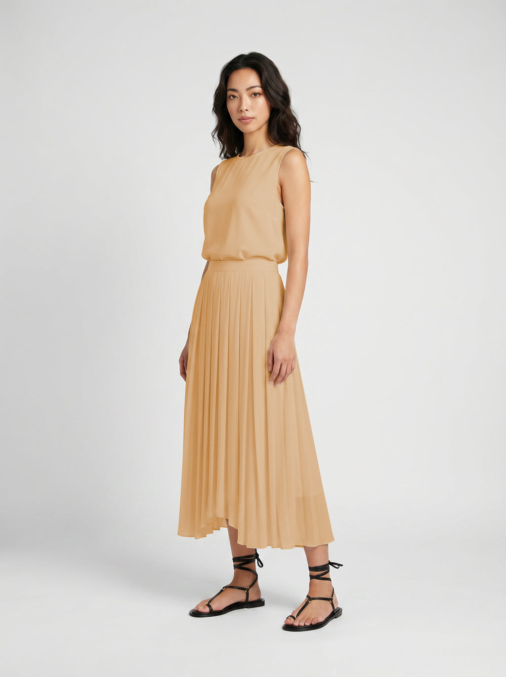 blush pleated organic silk skirt on model three quater view