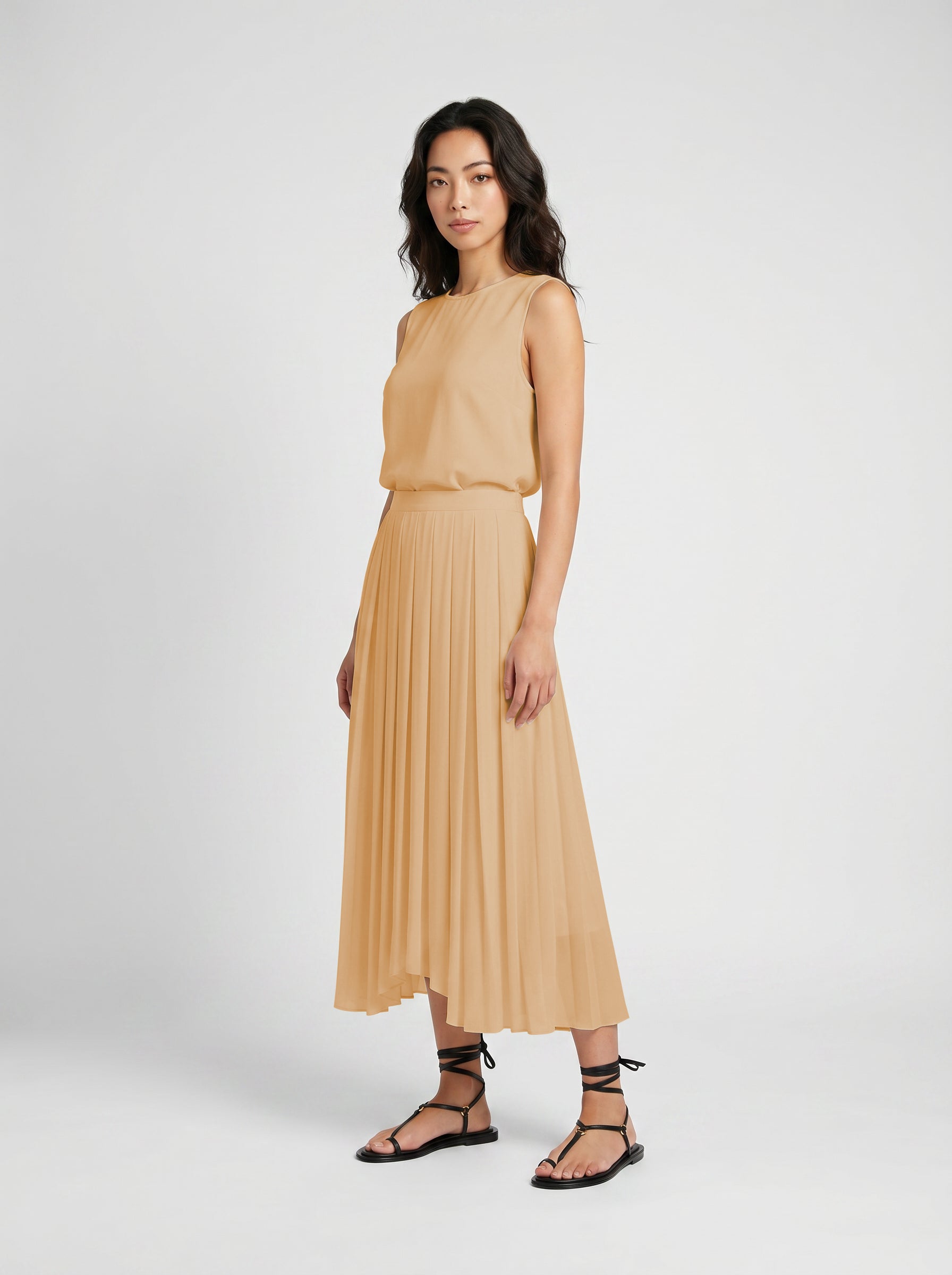 blush pleated organic silk skirt on model three quater view