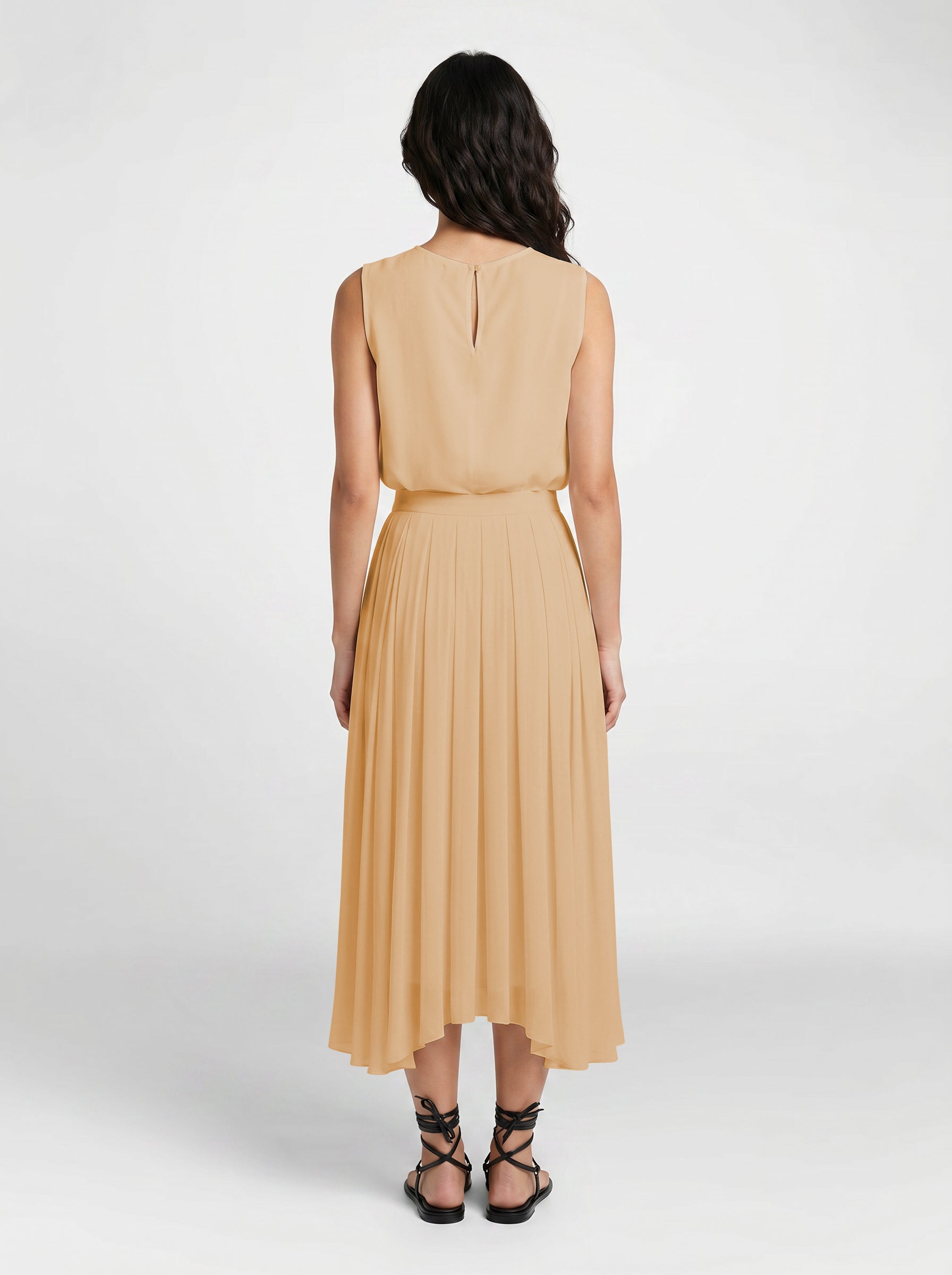 blush pleated organic silk skirt on model back view