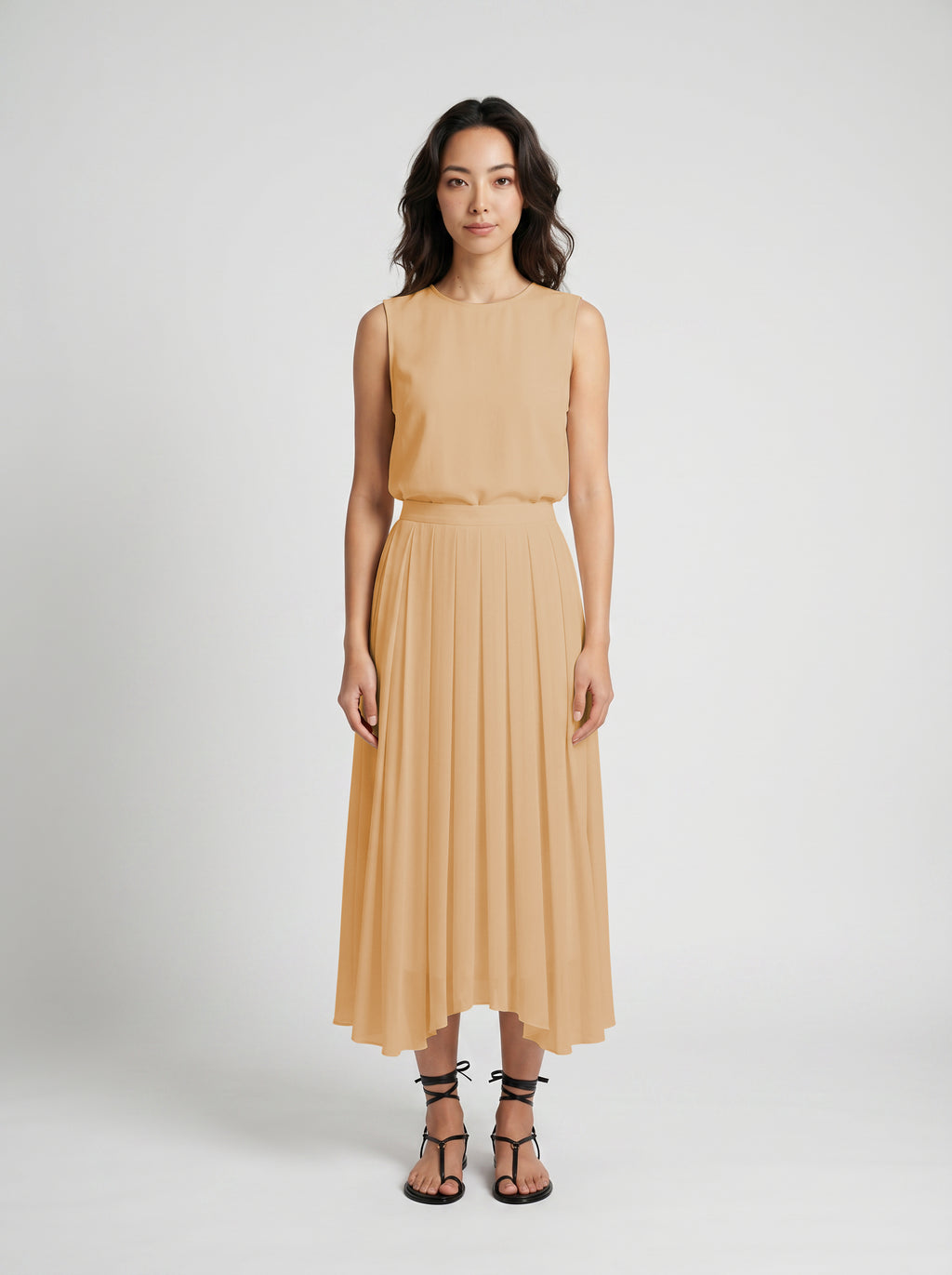 blush pleated organic silk skirt on model front view