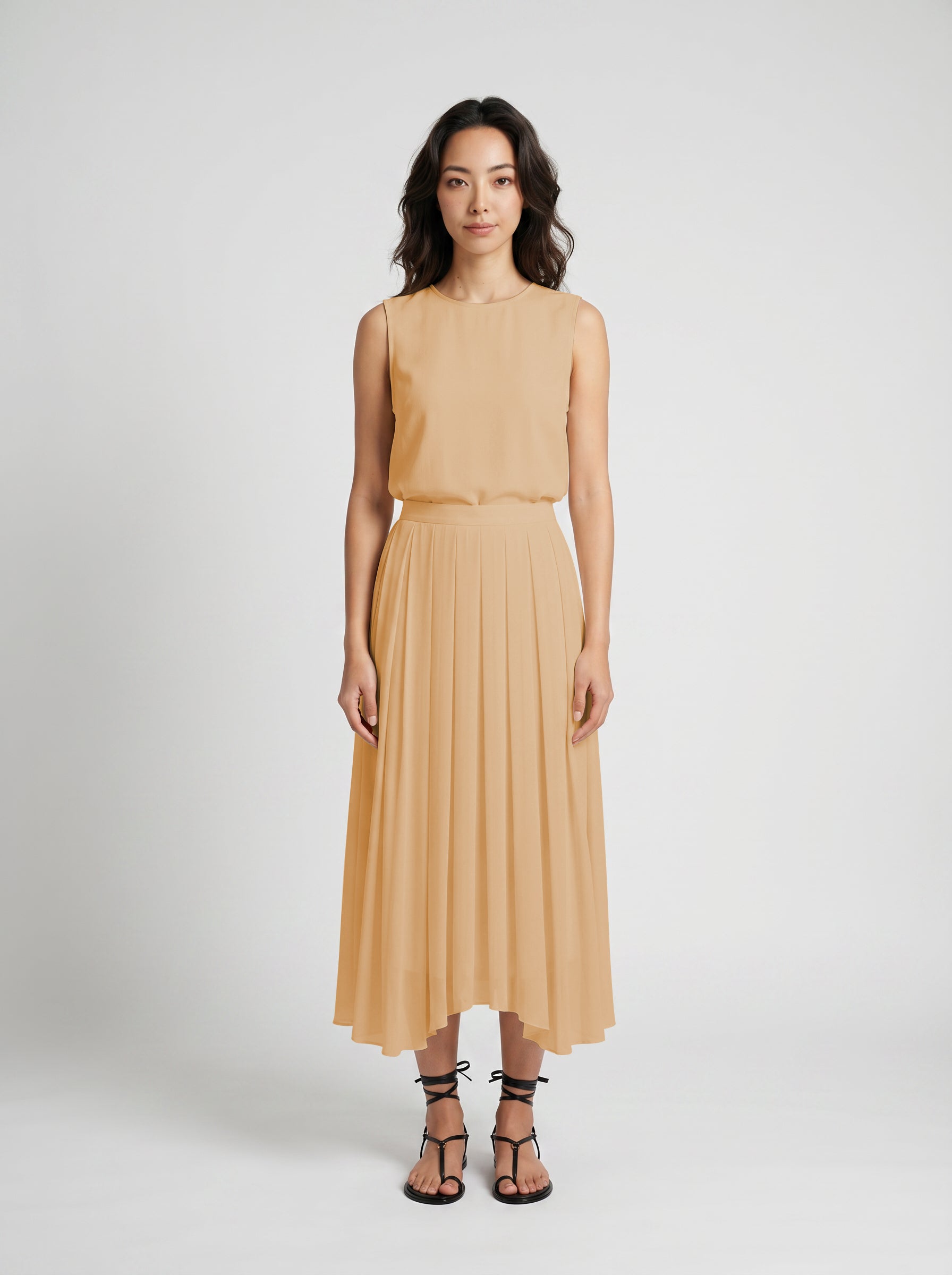 blush pleated organic silk skirt on model front view