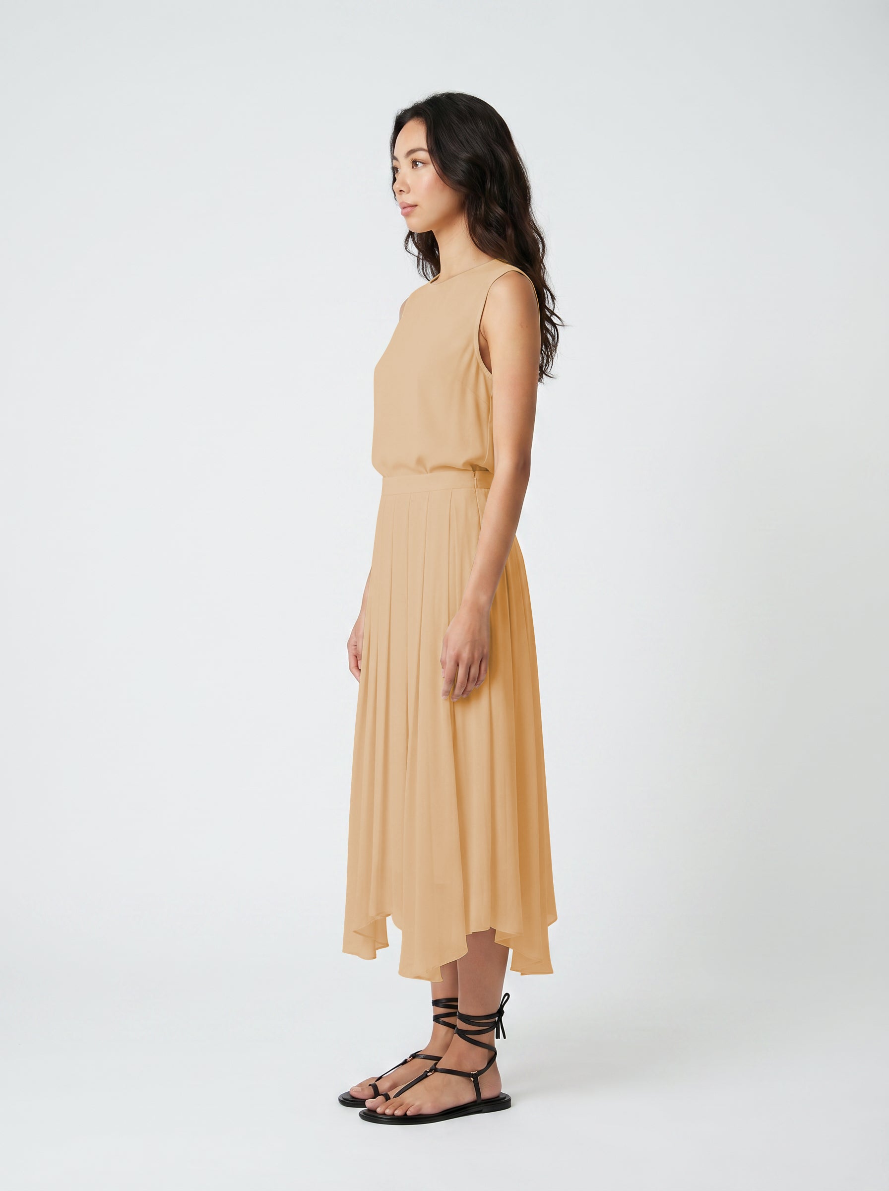blush pleated organic silk skirt on model side view