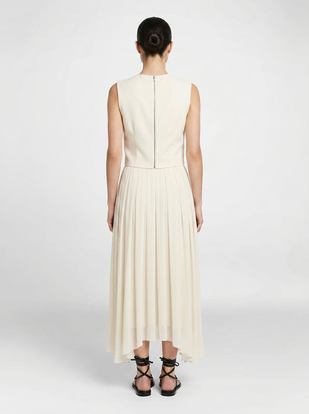 creme color Wool bodice top with silk pleated skirt on model back view