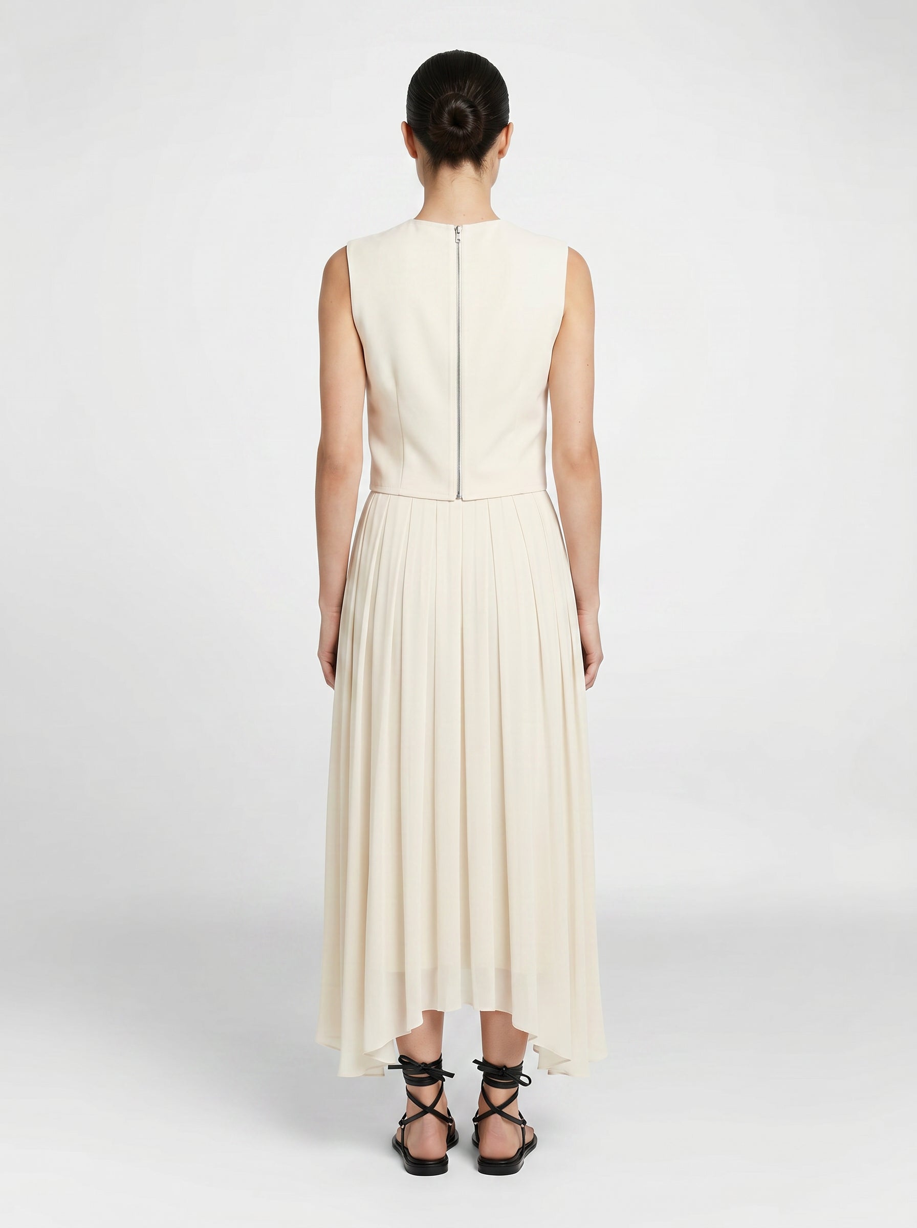 creme color Wool bodice top with silk pleated skirt on model back view