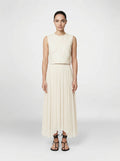 creme color Wool bodice top with silk pleated skirt on model front view
