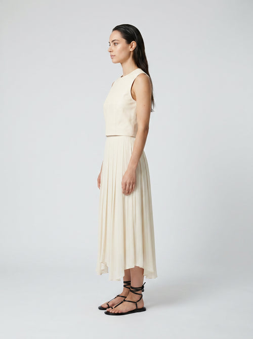 creme color Wool bodice top with silk pleated skirt on model side view