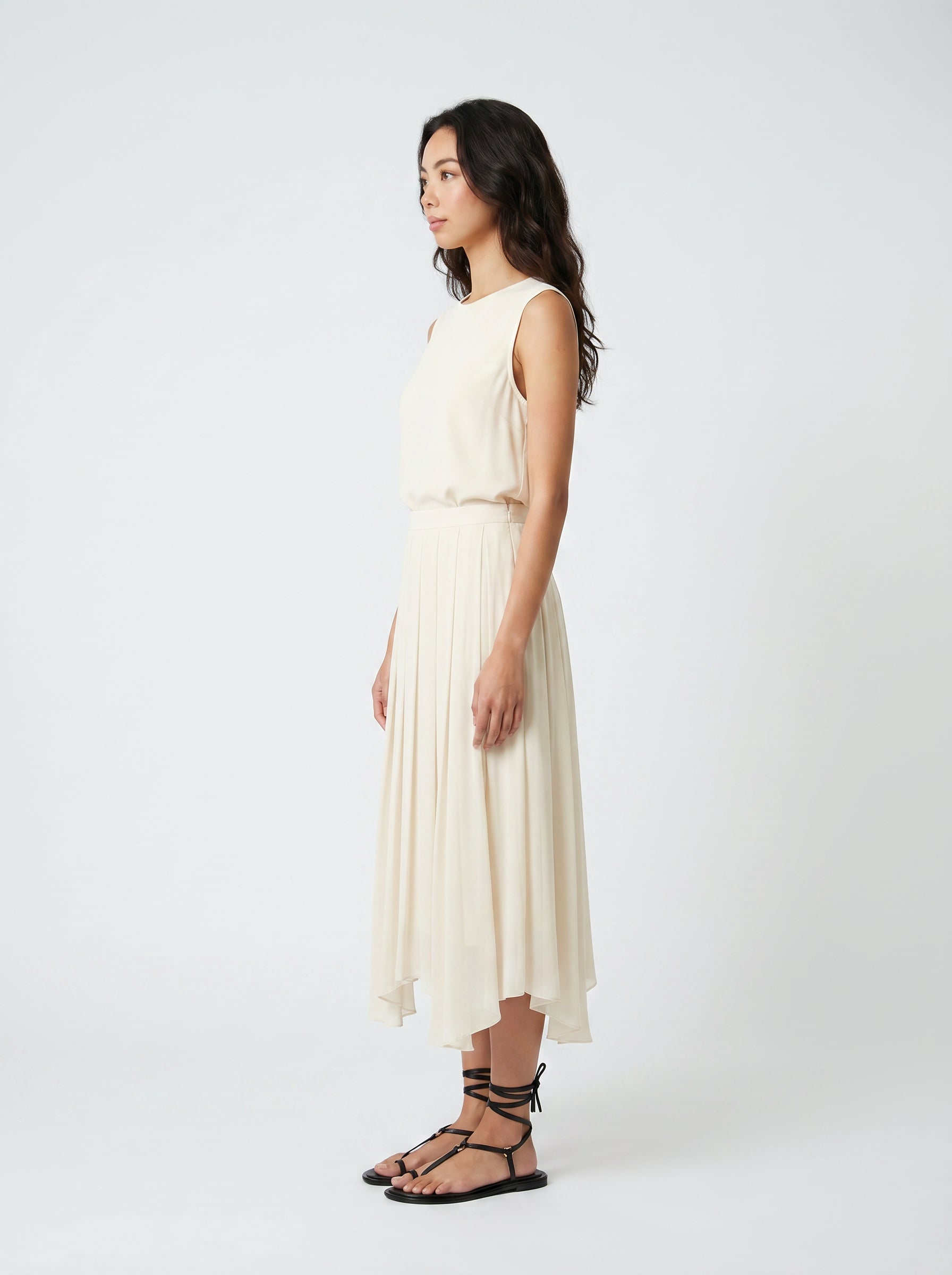 creme pleated organic silk skirt on model side view