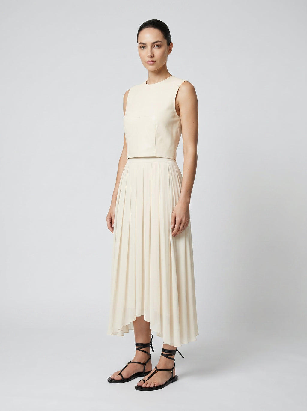 creme color Wool bodice top with silk pleated skirt on model 3/4 view