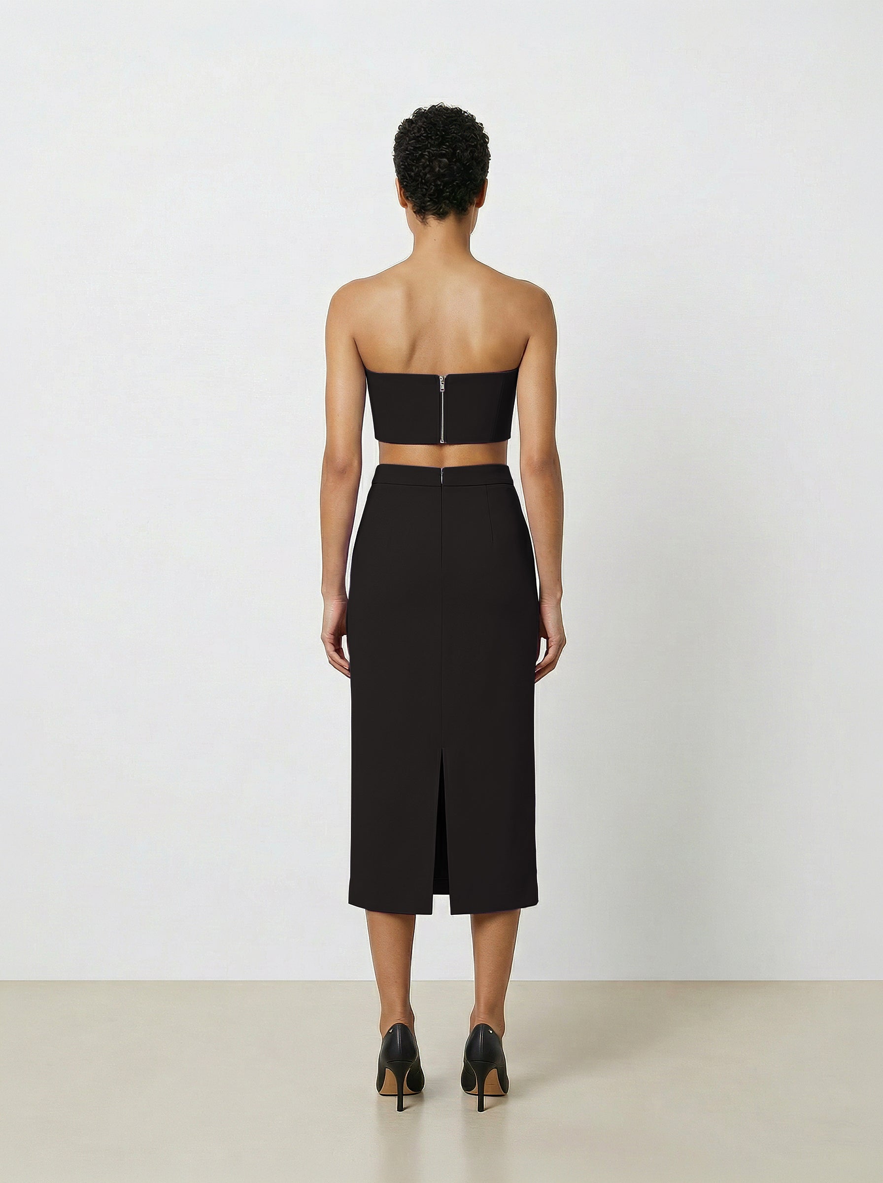 woman wearing black wool pencil skirt  back view on white back drop