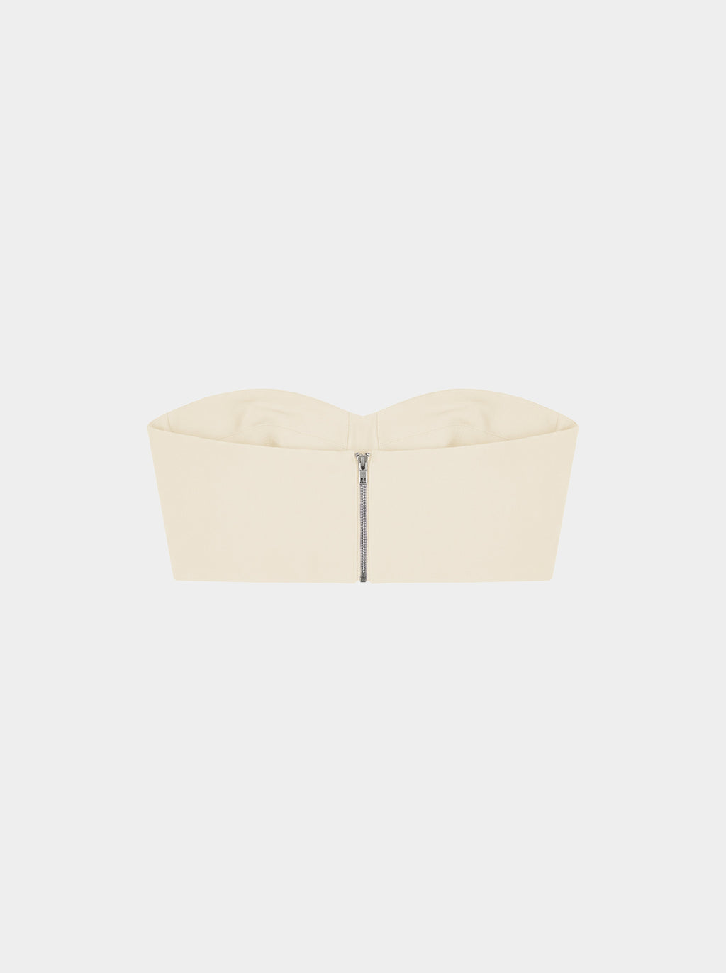 Beige strapless top with zipper on a white background