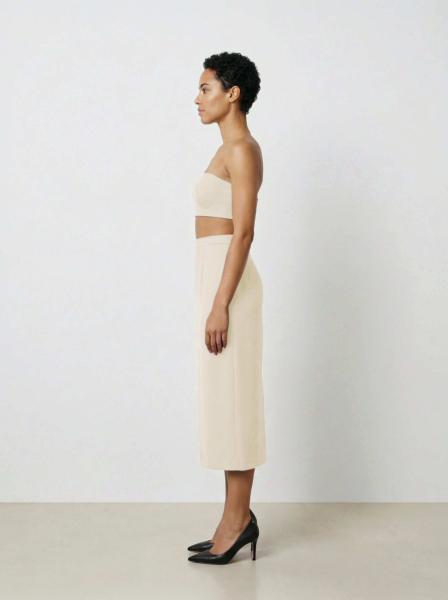 side view of Creme wool pencil skirt on model with white background
