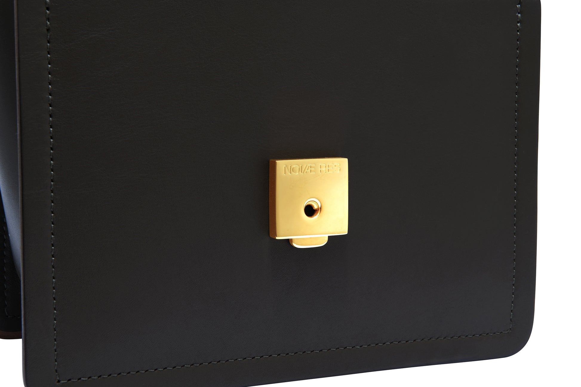 Novae Res Jemison Minor Leather Handbag made in Black Leather and Gold Hardware with Wide Long Strap Inside Lock View