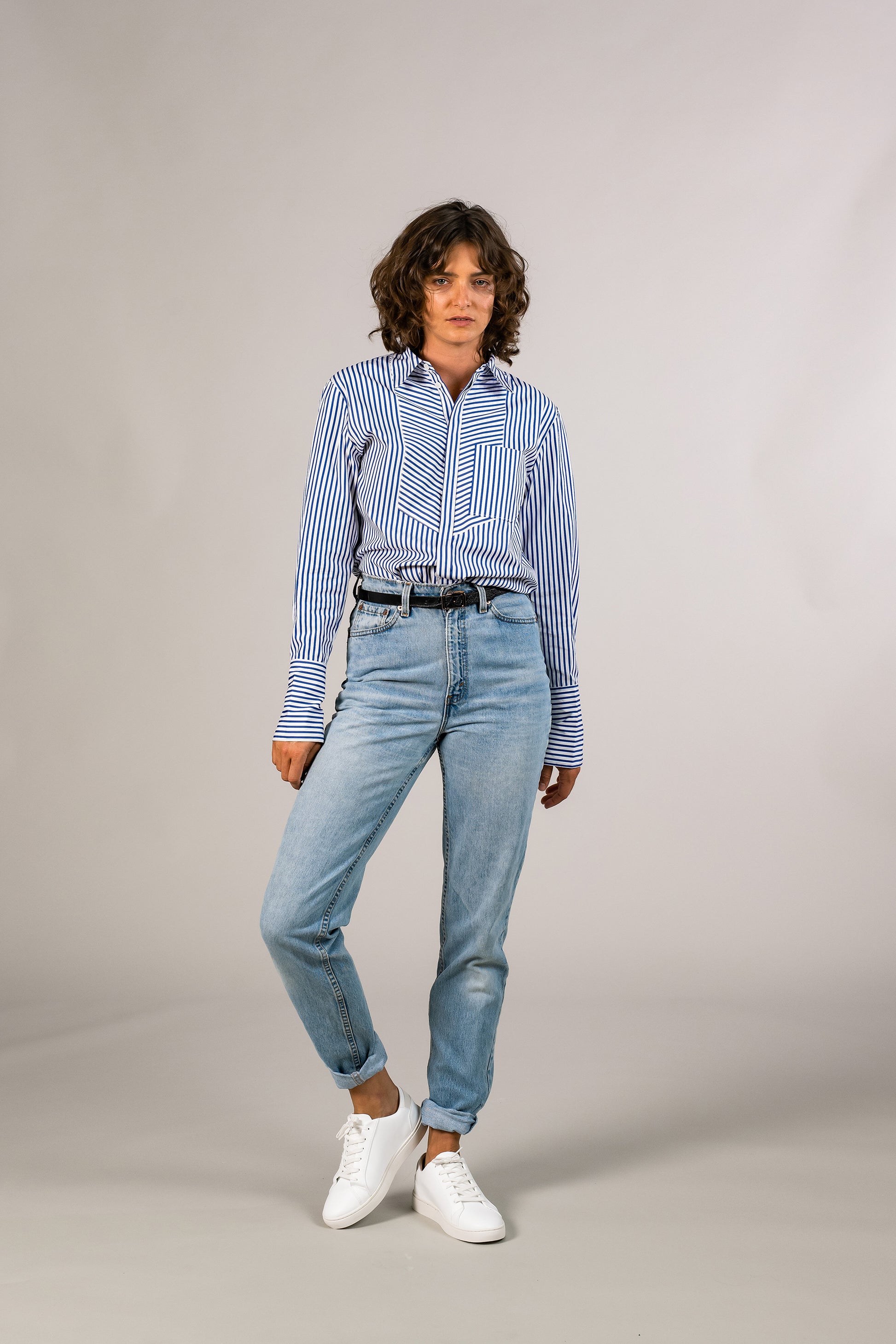 Tucked in womens blue stripe tuxedo shirt, 100% sustainable cotton poplin from Italy, long sleeve.