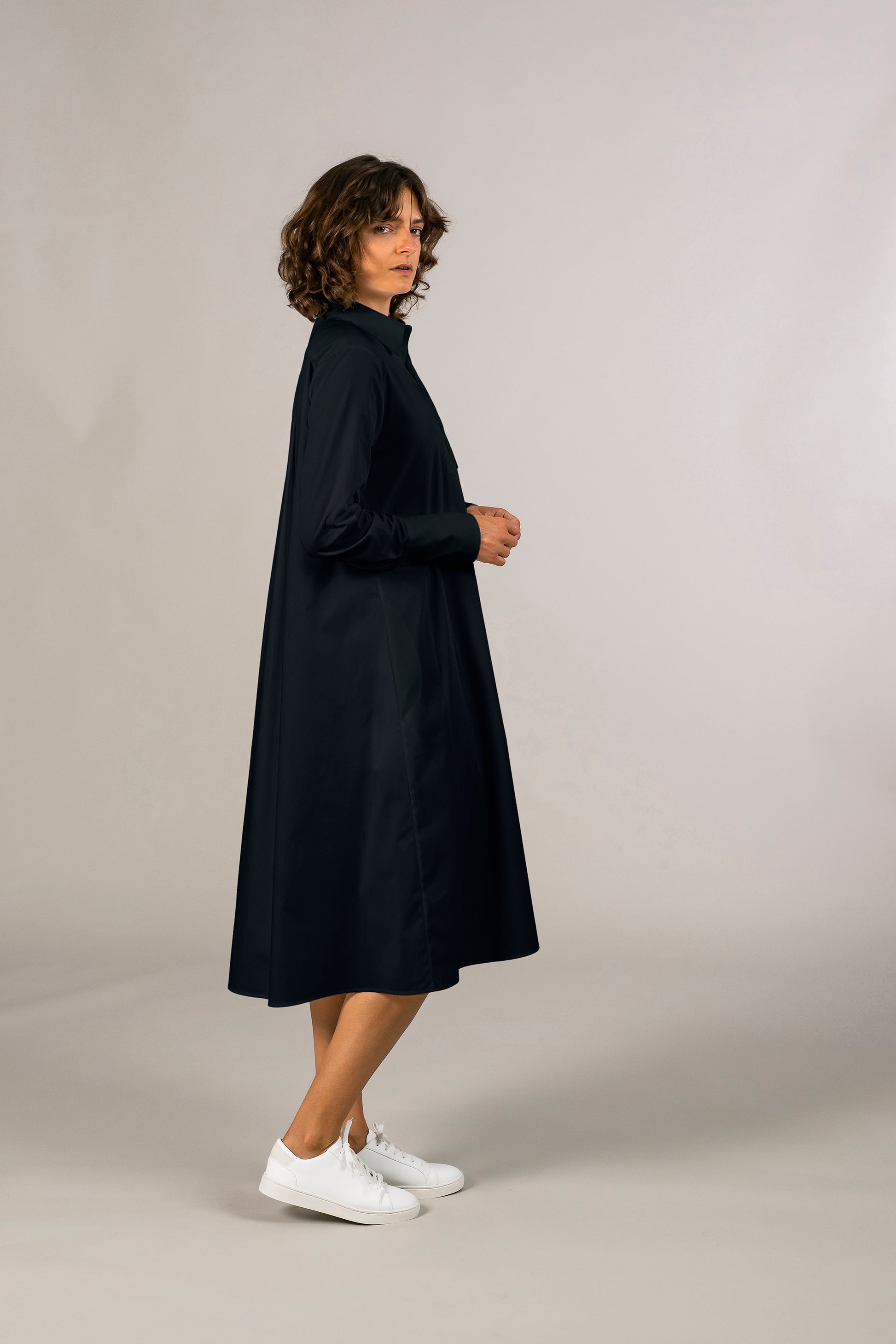 Side view of womens navy tuxedo shirt dress, 100% sustainable cotton poplin from Italy, long sleeve, button down knee length.