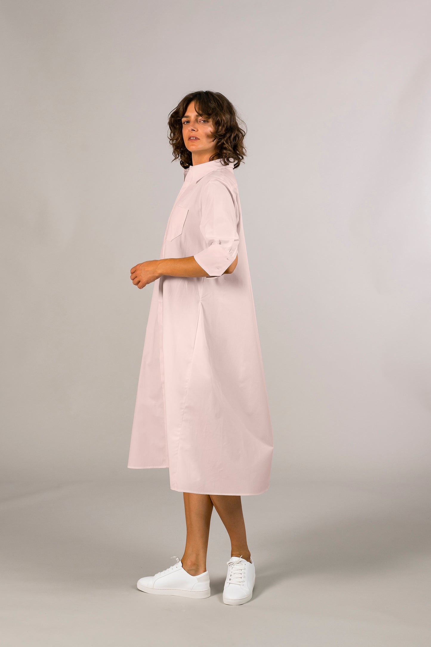 Profile of womens pink tuxedo shirt dress, 100% sustainable cotton poplin from italy, half sleeve, button down knee length. American made. 